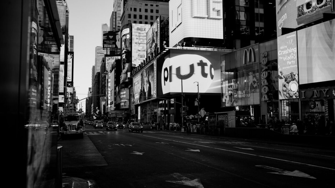 A black and white shot of a city street.